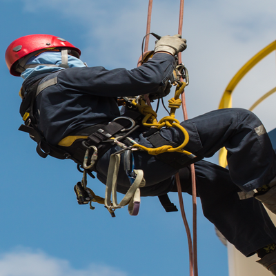 Tradesperson working at height with tools tethered by kevlar lanyard